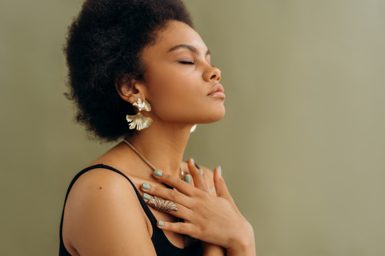 woman sitting on white cushion near glass window